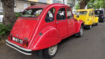 Photo for 19.03.2023 Two retro cars of the French brand Citroen 2CV red and yellow in Lisbon photo - Royalty Free Image