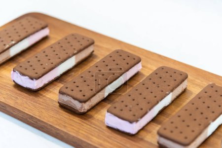 Photo for Homemade chocolate ice cream with chocolate cookies on a wooden board - Royalty Free Image