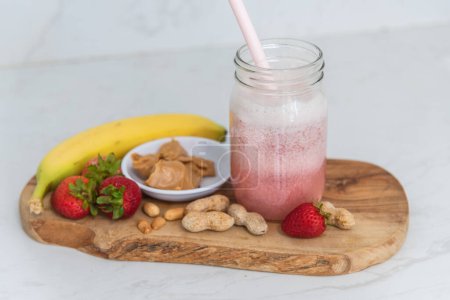Photo for Healthy smoothie with peanut butter, banana and strawberries - Royalty Free Image