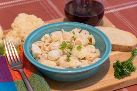 Photo for Pasta with cauliflower and glass of wine on table - Royalty Free Image