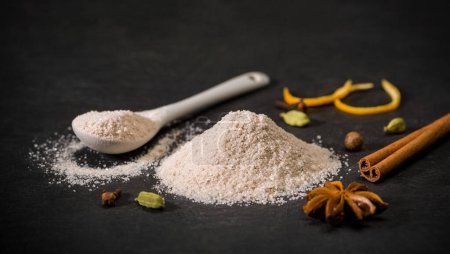 Photo for Spices for recipes. Milanese sugar. Spoon and pile of sugar, cinnamon, clove. Sweets. Ground spice. High quality photo - Royalty Free Image