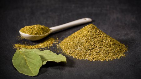 Photo for Aromatic spices bay leaf. Spoon and pile of ground dried, fresh laurel spice. Recipe ingredients photo - Royalty Free Image