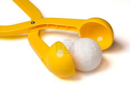 Foto de Fabricante de bolas de nieve de plástico amarillo con una bola de nieve. - Imagen libre de derechos