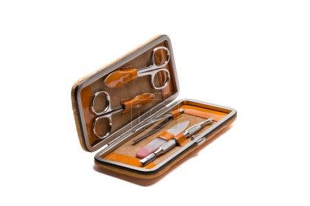 Foto de Conjunto de instrumentos y herramientas de manicura de acero en estuche de cuero naranja aislado sobre fondo blanco - Imagen libre de derechos