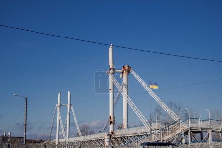 Photo for Izyum, Ukraine. - November 10, 2023. Pedestrian bridge over the River Siverska Donets. the supports are destroyed, but the bridge is still standing and people still walk on it - Royalty Free Image
