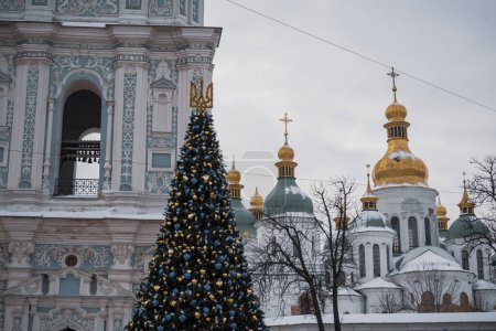 KYIV, UKRAINE  DECEMBER 6, 2023: THE COUNTRY'S MAIN TREE WAS INSTALLED ON SOFIVSKA AQUARE, WHICH WAS OFFICIALLY LIGHTED IN THE EVENING ON NICHOLAS DAY. PEOPLE ARE ALREADY WALKING NEAR HER