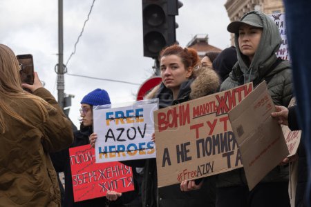 Kyiv, Ukraine - February 4, 2024. Relatives and friends with placards gathered in the center on Khreshchatyk to honor the fighters of "Azovstal", who have been in Russian captivity for almost two years. everyone is waiting for their return magic mug #700672728