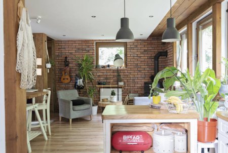 Photo for Natural wood in cozy interior in rural house. Brick wall, wooden floor and table with chair in design indoor in a cottage. Architecture. - Royalty Free Image