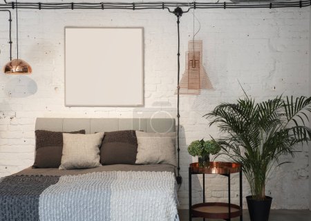 Photo for Modern bedroom with double bed with pillows, white bricks on the wall, stylish table and lamp. Apartment in industrial style with frame with mock up. Luxury. - Royalty Free Image