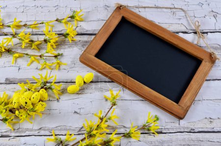 Photo for Easter card with easter egg and yellow flowers and empty wooden frame for wishes with mock up. - Royalty Free Image