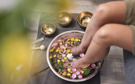 Photo for Female feet at spa salon with sound healing. Legs of woman in bowl with flowers and pedicure. Relax and aromatherapy. - Royalty Free Image