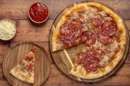 Foto de Fotografía gastronómica de pizza, salami, mozzarella, queso, tomate, salsa, orégano, picante - Imagen libre de derechos