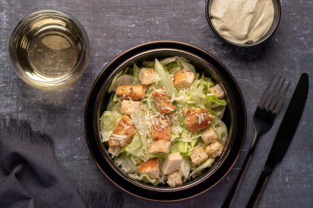 Photo for Food photography of caesar salad, chicken, iceberg, lettuce, parmesan, croutons, sauce - Royalty Free Image