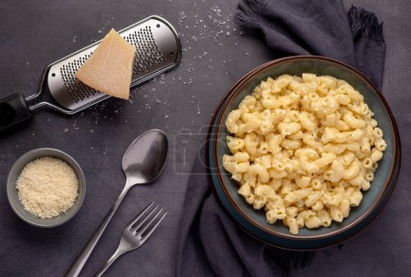 Photo for Food photography of pasta, macaroni with cheese, grated parmesan, cheddar, noodles, creamy - Royalty Free Image