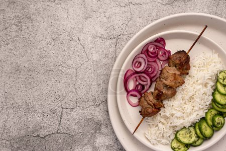 Photo for Blank food photography of grilled meat, kebab, bbq, roasted, pork, lamb, marinade, onion, rice, salad, cucumber - Royalty Free Image
