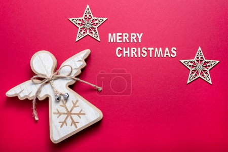 Foto de Fotografía de fondo rojo de estrellas de Navidad, ángel de madera, en blanco, espacio para copiar, tarjeta - Imagen libre de derechos