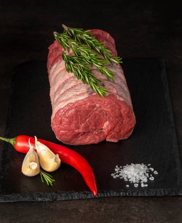 Photo for Food photography of beef, raw steak, butcher, fillet, meat, black board, garlic, herbs, salt, chili - Royalty Free Image
