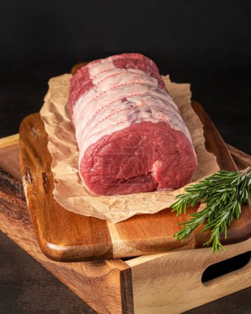 Photo for Food photography of beef, raw steak, butcher, fillet, meat, wooden board, herbs - Royalty Free Image