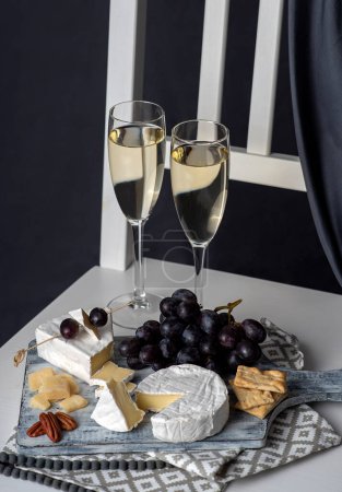 Photo for Food photography of white wine, cheese, grape, salami - Royalty Free Image