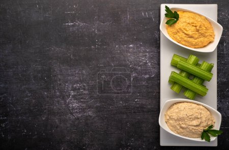 Photo for Food photography of appetizer, hummus, celery - Royalty Free Image