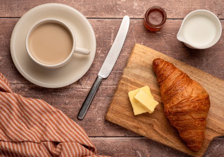 Photo for Food photography of breakfast, croissant, cappuccino, butter,  jam, milk - Royalty Free Image