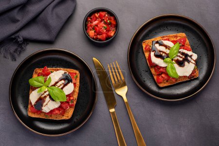 Photo for Food photography of bruschetta, toast, cheese, mozzarella, tomato, basil, balsamic - Royalty Free Image