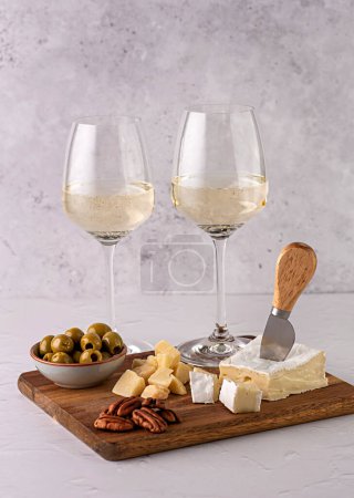 Photo for Food photography of white wine, cheese, parmesan, brie, olives, nuts, pecan, appetizer - Royalty Free Image