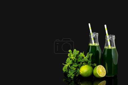 Photo for Background photography of green vegetable juice, vegetable fresh, lime, mint, bottle with straw on a black background, blank, copy space, add text. - Royalty Free Image