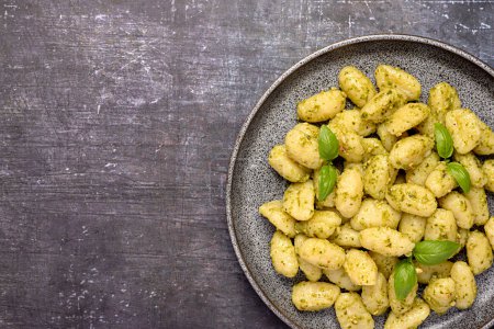 Photo for Blank food photography of gnocchi; pesto; basil; parmesan; cheese; potato; prepared; sauce; vegetarian; cooking; italy; italian; mediterranean; background; homemade meal - Royalty Free Image