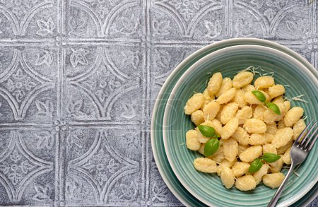 Photo for Blank food photography of gnocchi; basil; parmesan; cheese; potato; prepared; sauce; pasta; vegetarian; cooking; italy; italian; mediterranean; background; homemade meal - Royalty Free Image