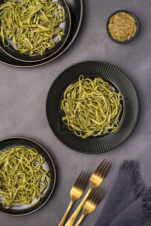 Photo for Food photography of pasta, linguine, fettuccine, trenette, spinach, pesto, durum, wheat, semolina, fork, background, italian - Royalty Free Image