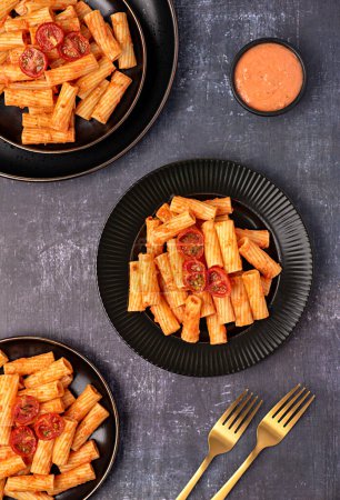Photo for Food photography of pasta, rigatoni with  roasted tomatoes, sauce, olive oil, durum, wheat, semolina, background, italian - Royalty Free Image