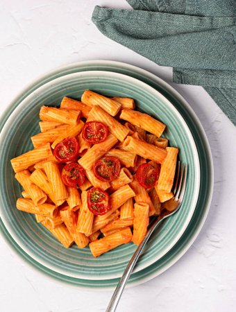 Photo for Food photography of pasta, rigatoni with  roasted tomatoes, sauce, olive oil, durum, wheat, semolina, fork, background, italian - Royalty Free Image