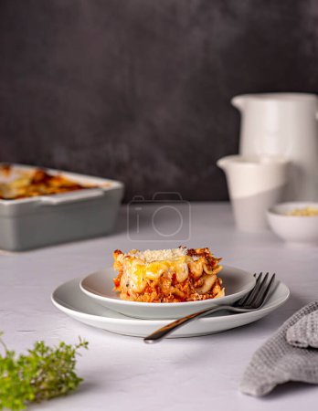 Photo for Food photography of lasagna, quiche, casserole, cheese, tomato sauce, parmesan, plate, towel, stand, ground rustic, italian food, pasta, bolognese - Royalty Free Image