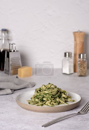 Photo for Food photography of pasta; tagliatelle, fettuccine; trenette; spinach; oregano; parmesan; cheese; sauce, olive; oil; durum; wheat; semolina; fork; background; italian - Royalty Free Image