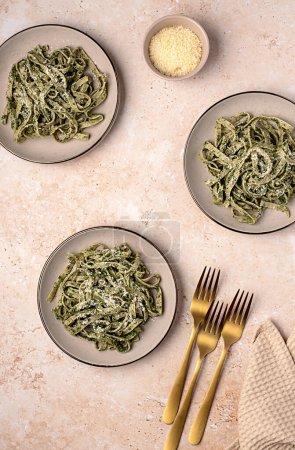 Photo for Food photography of pasta; tagliatelle, fettuccine; trenette; spinach; oregano; parmesan; cheese; sauce, olive; oil; durum; wheat; semolina; fork; background; italian - Royalty Free Image