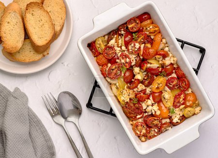 Photo for Food photography of salad, baked tomato; feta, cheese; garlic; thyme; toast; vegetable, bread - Royalty Free Image