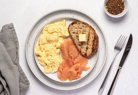 Photo for Food photography of  breakfast; scrambled egg; brunch; omelette; smoked salmon; toast, wholegrain bread, seasoning - Royalty Free Image