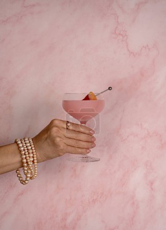 Photo for Photography of Cocktail with grapefruit, Drink, Mocktail, Freshness, Elegance, woman, jewellery, pearls, bracelet, beads, ring, pink, Celebration, Glamour - Royalty Free Image