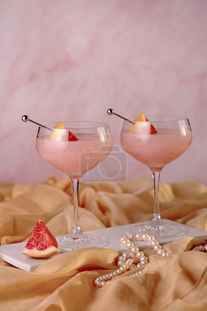 Photo for Photography of Cocktail with grapefruit, Drink, Mocktail, Freshness, Elegance, woman, jewellery, pearls, bracelet, beads, pink, Celebration, Glamour - Royalty Free Image