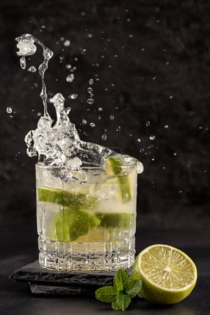 Photo for Photography of cocktail with lime, splash, mojito, mint, ice, drink, mocktail, freshness, elegance, celebration, glamour - Royalty Free Image