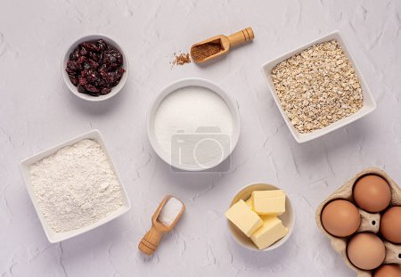 Photo for Food photography of raw ingredients of oat biscuits, cookie, dough, egg, sugar, white flour, butter, dried cranberry, vanilla, bake, bakery - Royalty Free Image