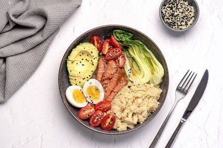 Photo for Food photography of healthy breakfast, brunch, buddha bowl, egg, salmon, bok choy, tomatoes, quinoa, avocado, sesame seeds, protein, carbohydrate, dieting - Royalty Free Image