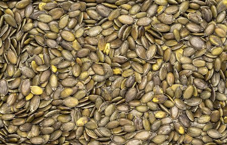 Téléchargez les photos : Macro photographie vierge de graines de citrouille crues, pelées, entières, collation, beaucoup, protéines, calories, graisse, tas, manger, savoureux, - en image libre de droit