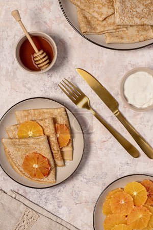 Photo for Food photography of crepes with bloody orange, pancake, pastry, stack, shrove tuesday, shrovetide, honey, cream, yogurt, maslenitsa, thin, dessert, sweet - Royalty Free Image