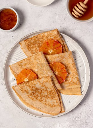 Photo for Food photography of crepes with bloody orange, pancake, pastry, stack, shrove tuesday, honey, maslenitsa, thin, jam, dessert, sweet - Royalty Free Image