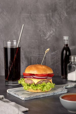 Photo for Food photography of hamburger, cheese, sandwich, beef, bun, lettuce, tomato, onion, soda, drink, cola, background, hungry, american, restaurant, snack, meal - Royalty Free Image