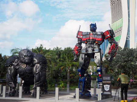 Photo for Singapore - Mar 20, 2023: Rise Of The Beasts Statues World Tour at Gardens By The Bay. Photographer taking photo of Optimus Prime Statue. - Royalty Free Image