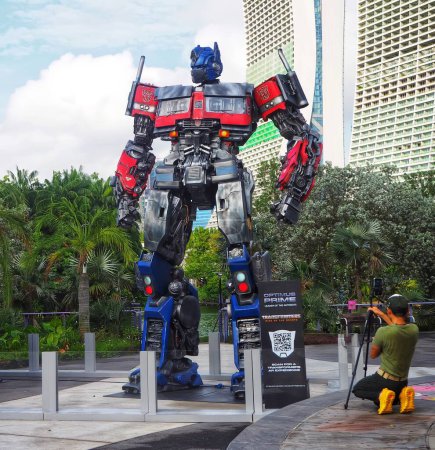 Photo for Singapore - Mar 20, 2023: Rise Of The Beasts Statues World Tour at Gardens By The Bay. Photographer taking photo of Optimus Prime Statue. - Royalty Free Image