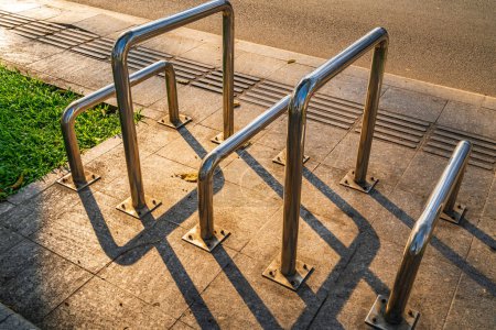 Photo for Stainless steel bollard barriers at park with golden sunset - Royalty Free Image